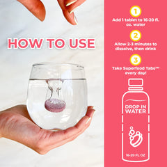 Superfood Tabs strawberry lemonade tablets dissolving in water for detox support
