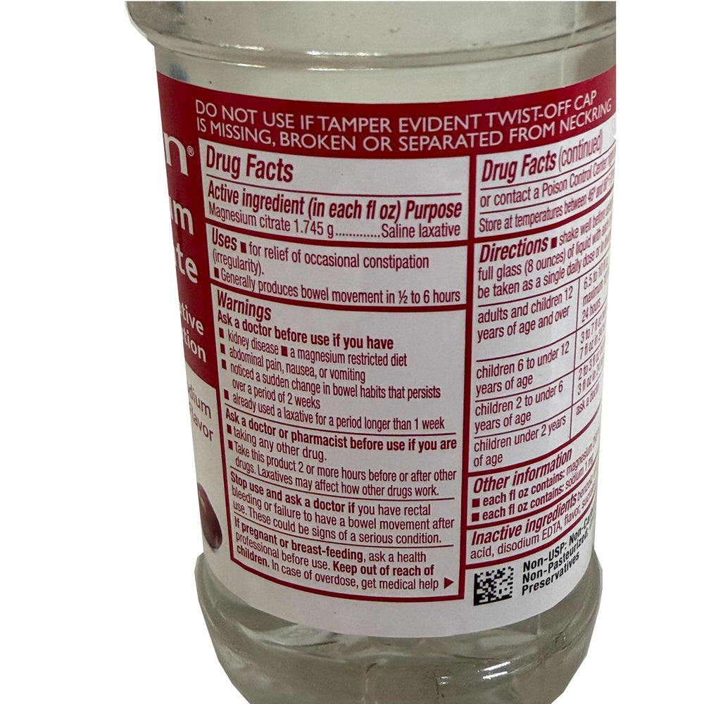 Swan Magnesium Citrate Cherry liquid filling a spoon for measurement.