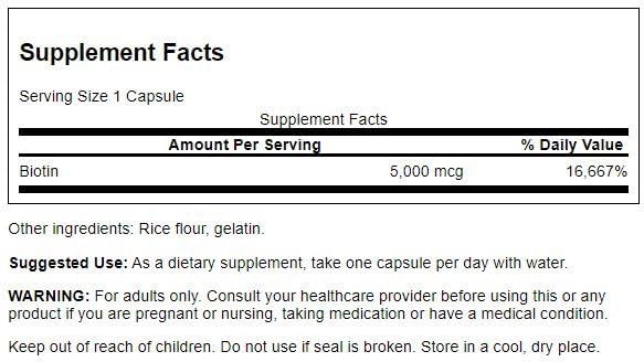 Close-up of Swanson Biotin B7 bottle pouring capsules for metabolism support.