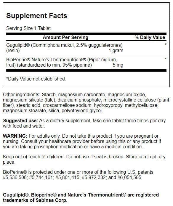 Swanson Gugulipid tablet close-up indicating easy daily supplementation with meals.