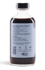 Spoon-dispensed Sweet's Elderberry syrup for easy daily use.
