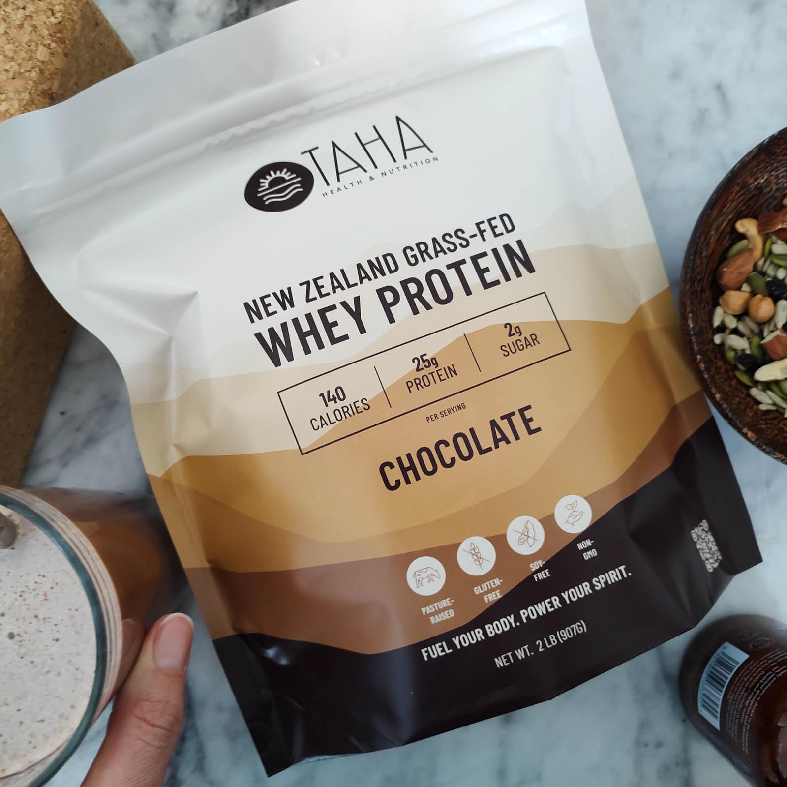 Label close-up of Taha chocolate whey protein highlighting NZ dairy