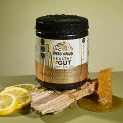 Dosing scoop beside Terra Origin powder for easy daily use.