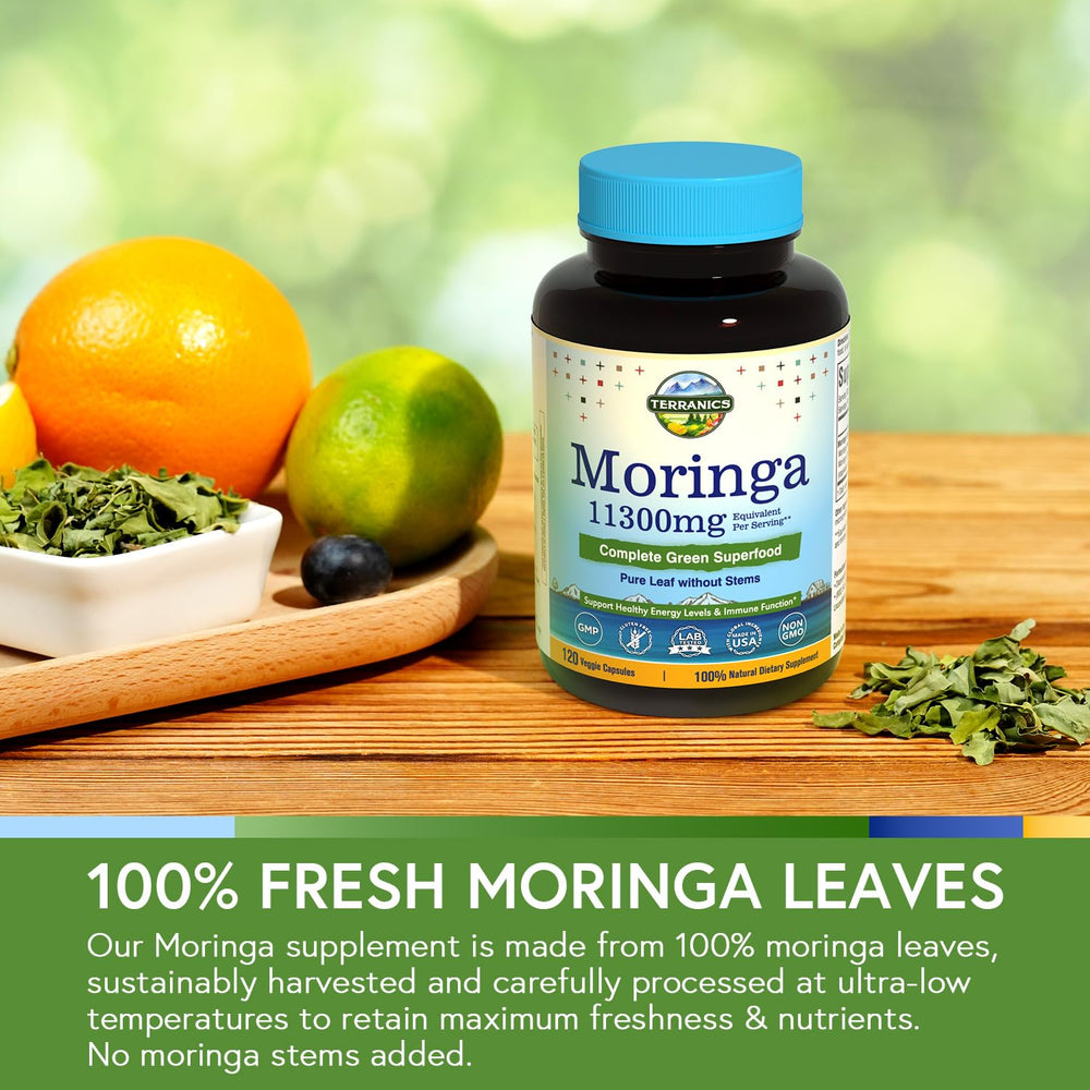 Terranics Moringa capsules with leaves, capsules next to greens