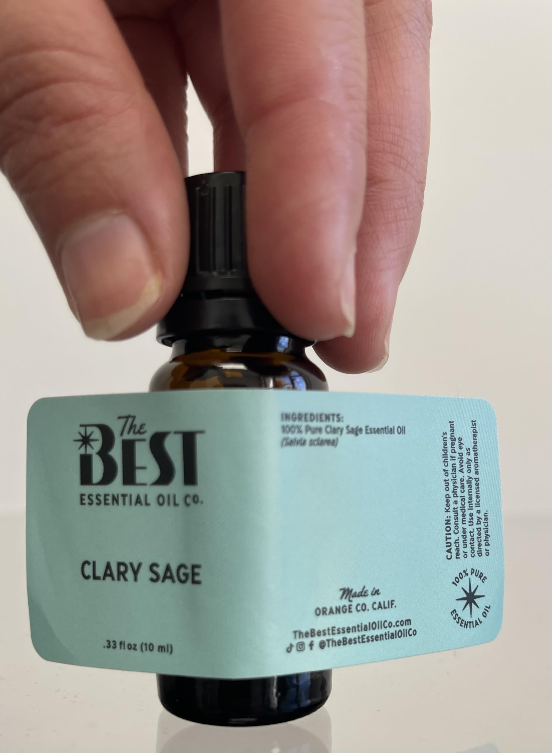 The Best Essential Oil Co Clary Sage droplets on skin show rich texture