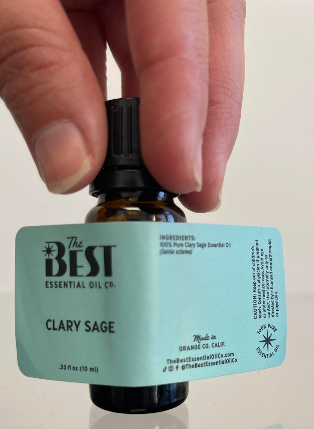 The Best Essential Oil Co Clary Sage droplets on skin show rich texture