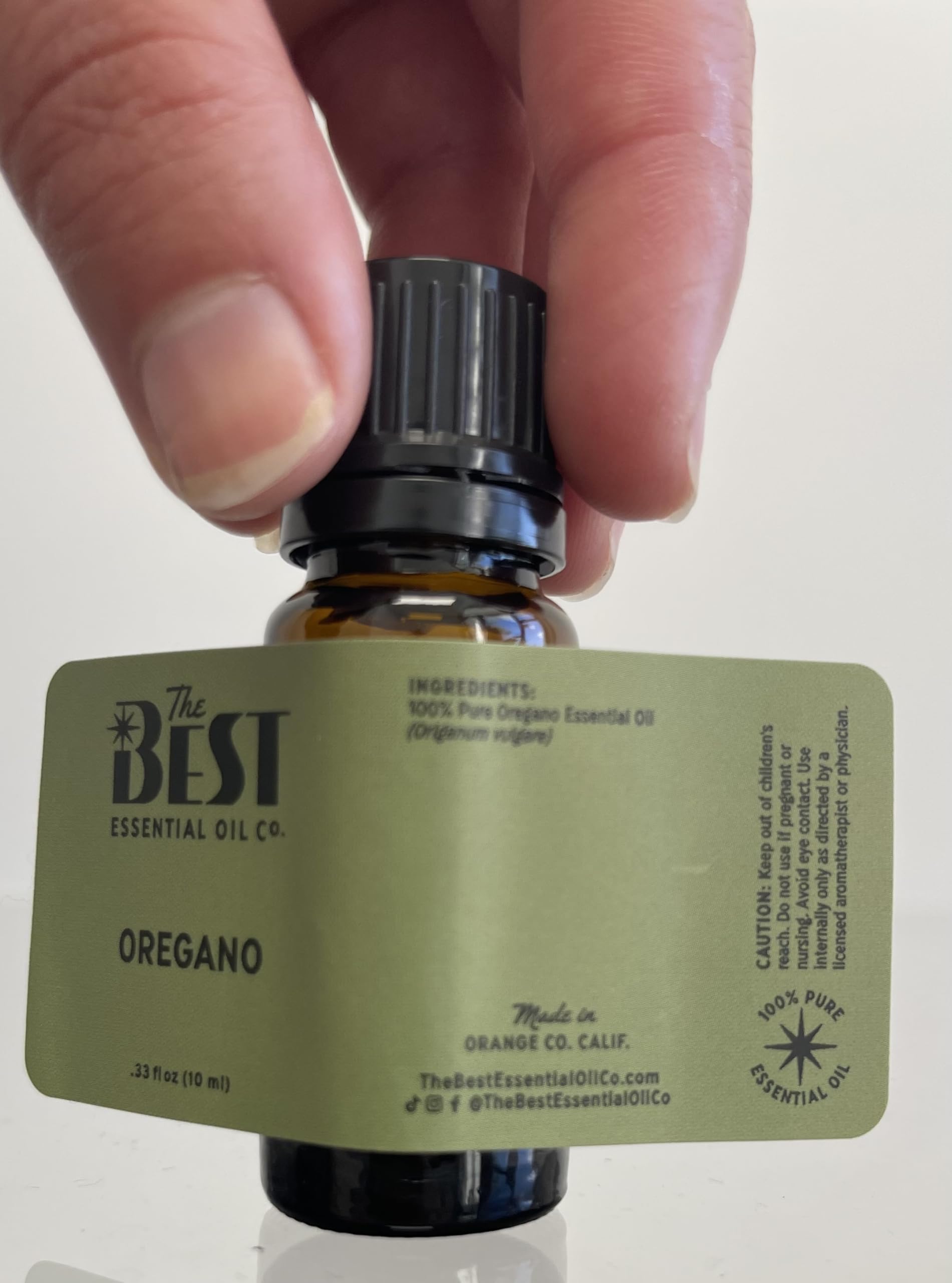 The Best Essential Oil Co oregano essential oil in a clean bathroom setup for scent enhancement
