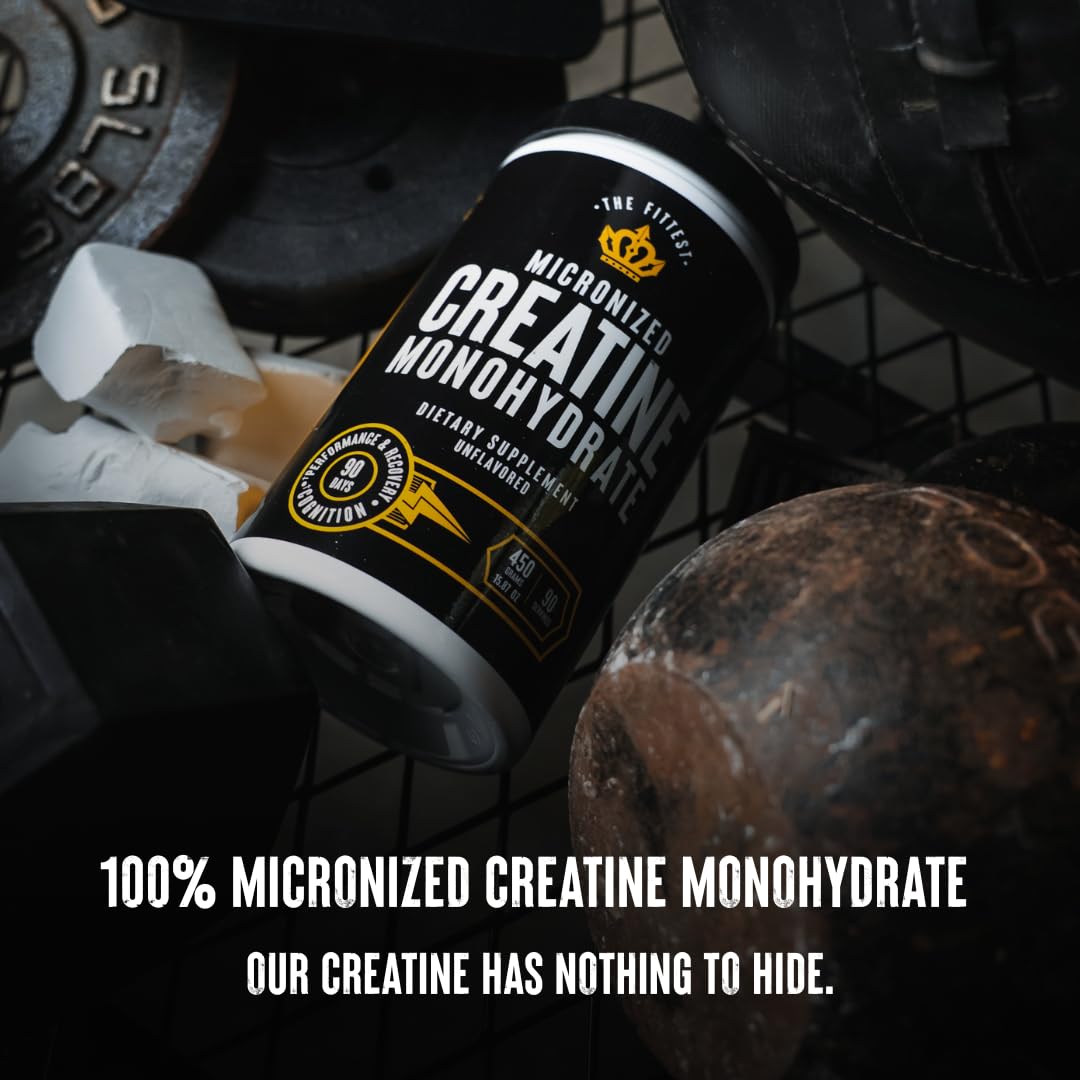 The Fittest Ever creatine powder beside a glass and scoop