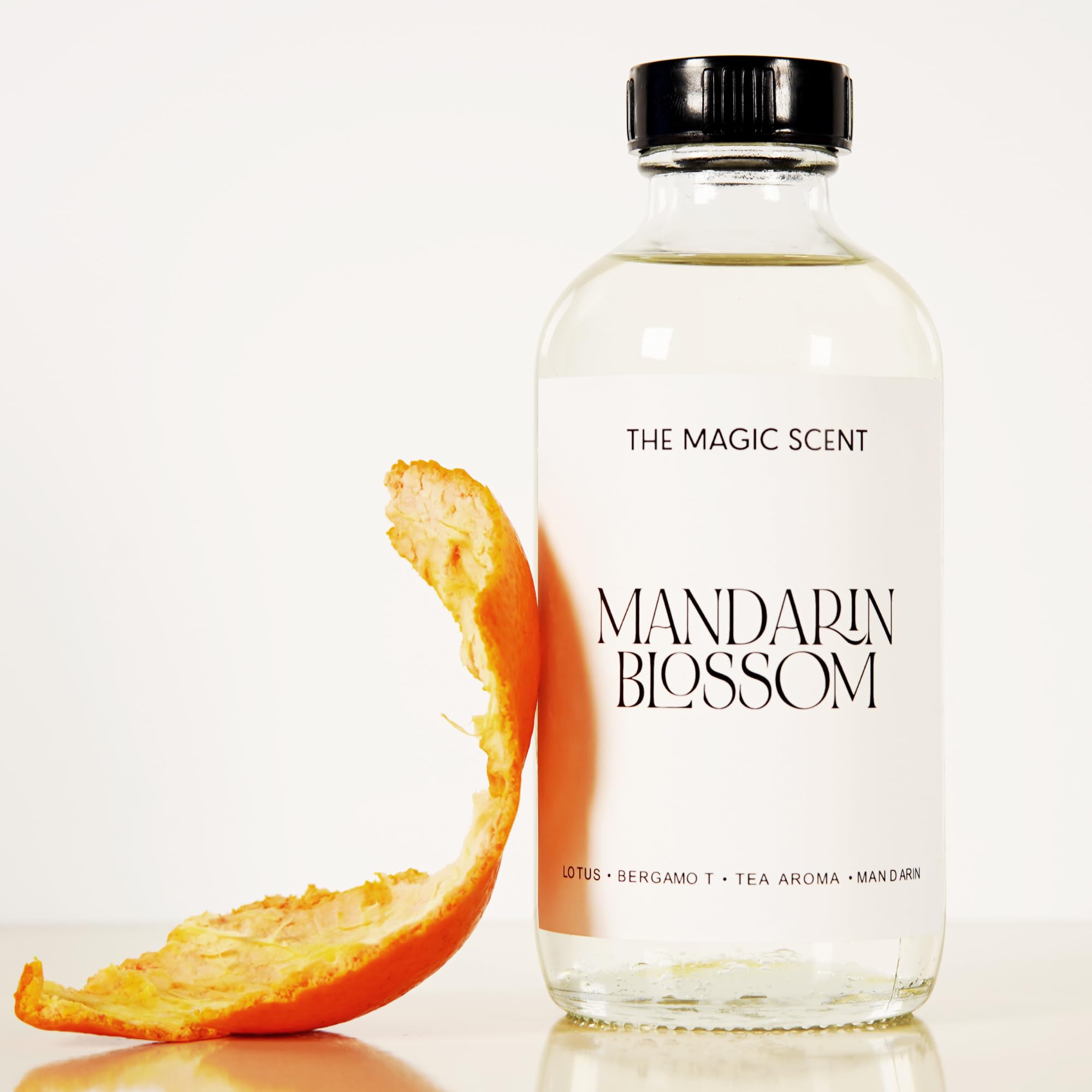 The Magic Scent Mandarin Blossom bottle label shows sandalwood and vanilla notes