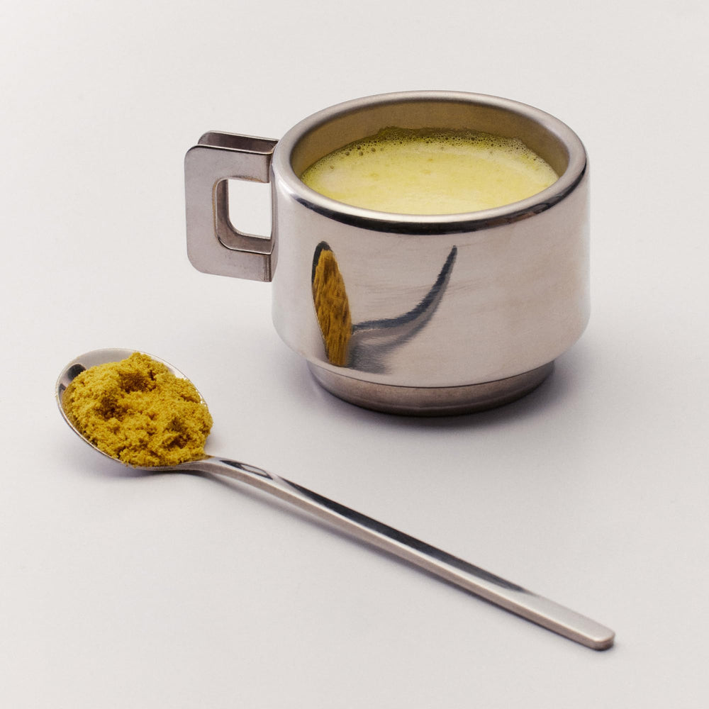 The Nue Co Debloat spoon on the table suggests a simple daily routine.