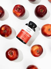 Pouring Thomas' apple cider vinegar bottle highlights an easy wellness routine.