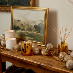 Thymes Frasier Fir candle features cedarwood and sandalwood for warmth and calm.
