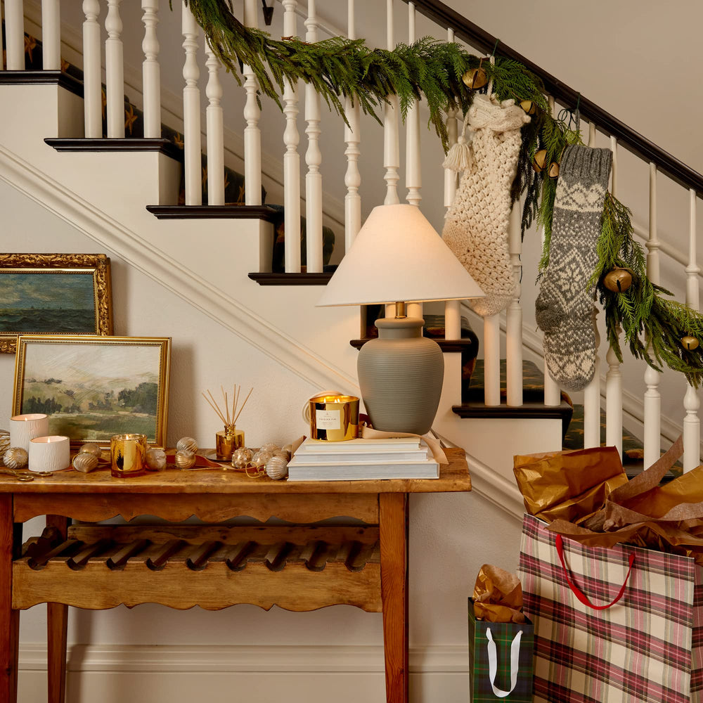 Thymes Frasier Fir candle on display shows elegant craftsmanship and decorative charm.