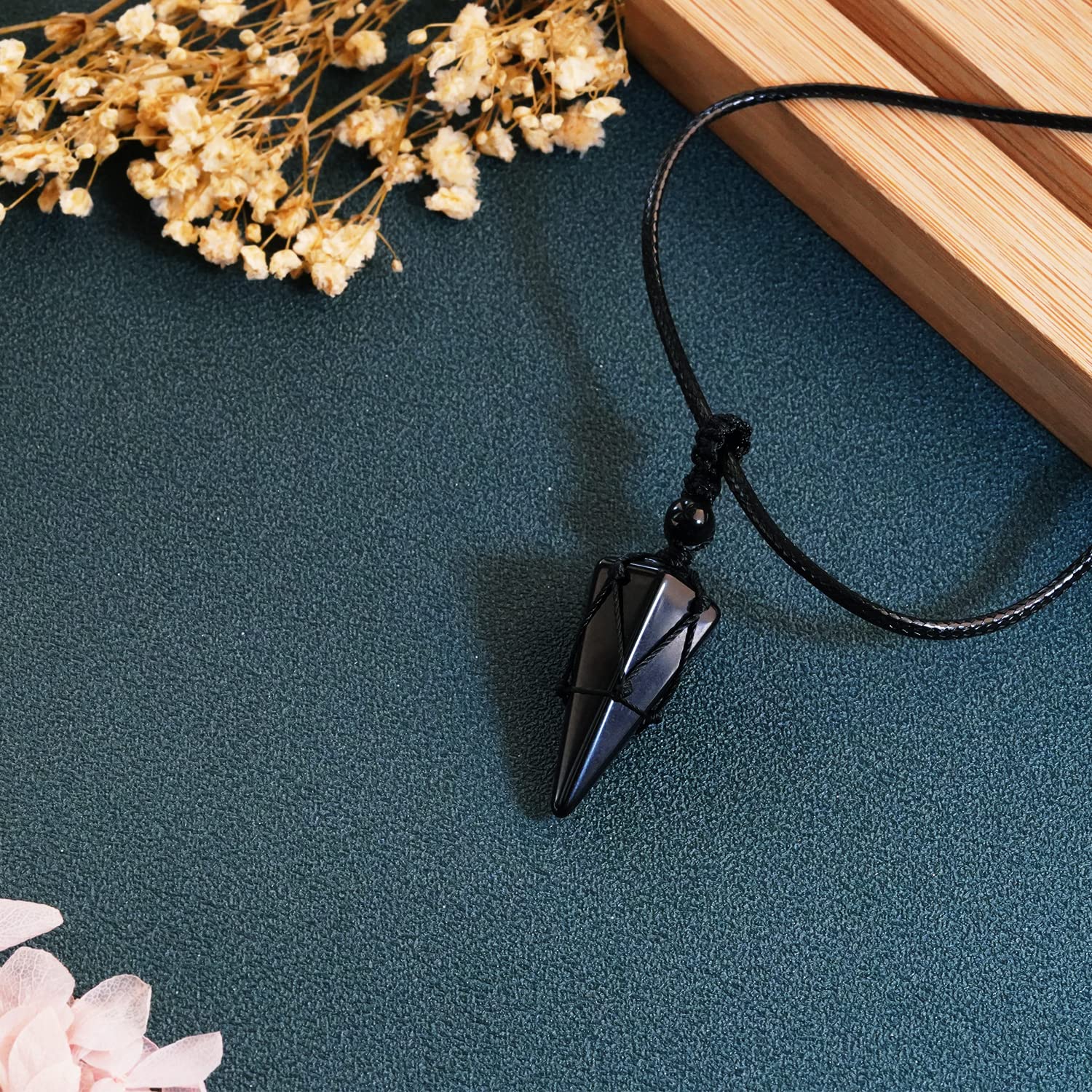 TIKCAUZ Black Obsidian pointed pendant with hexagonal facets for grounding and emotional balance.