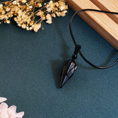 TIKCAUZ Black Obsidian pointed pendant with hexagonal facets for grounding and emotional balance.
