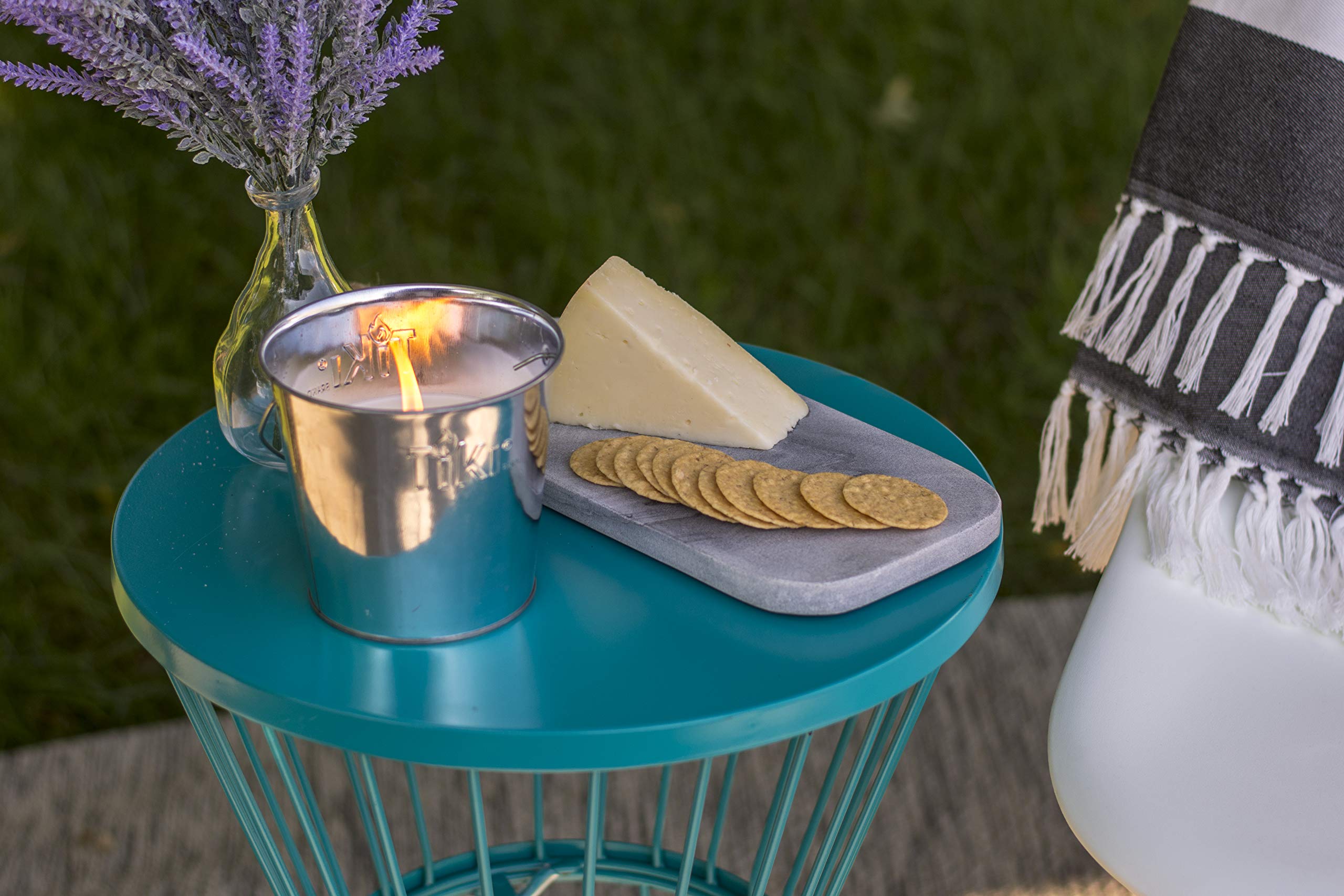 Citronella candle in metal bucket creates warm ambiance and pest deterrence