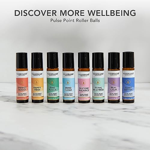 Travel-friendly Tisserand Happy Vibes roller ball beside passport