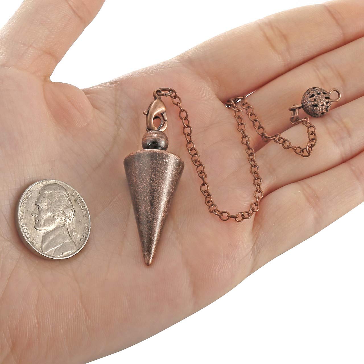 Top Plaza cone pendant detail highlighting copper balance.