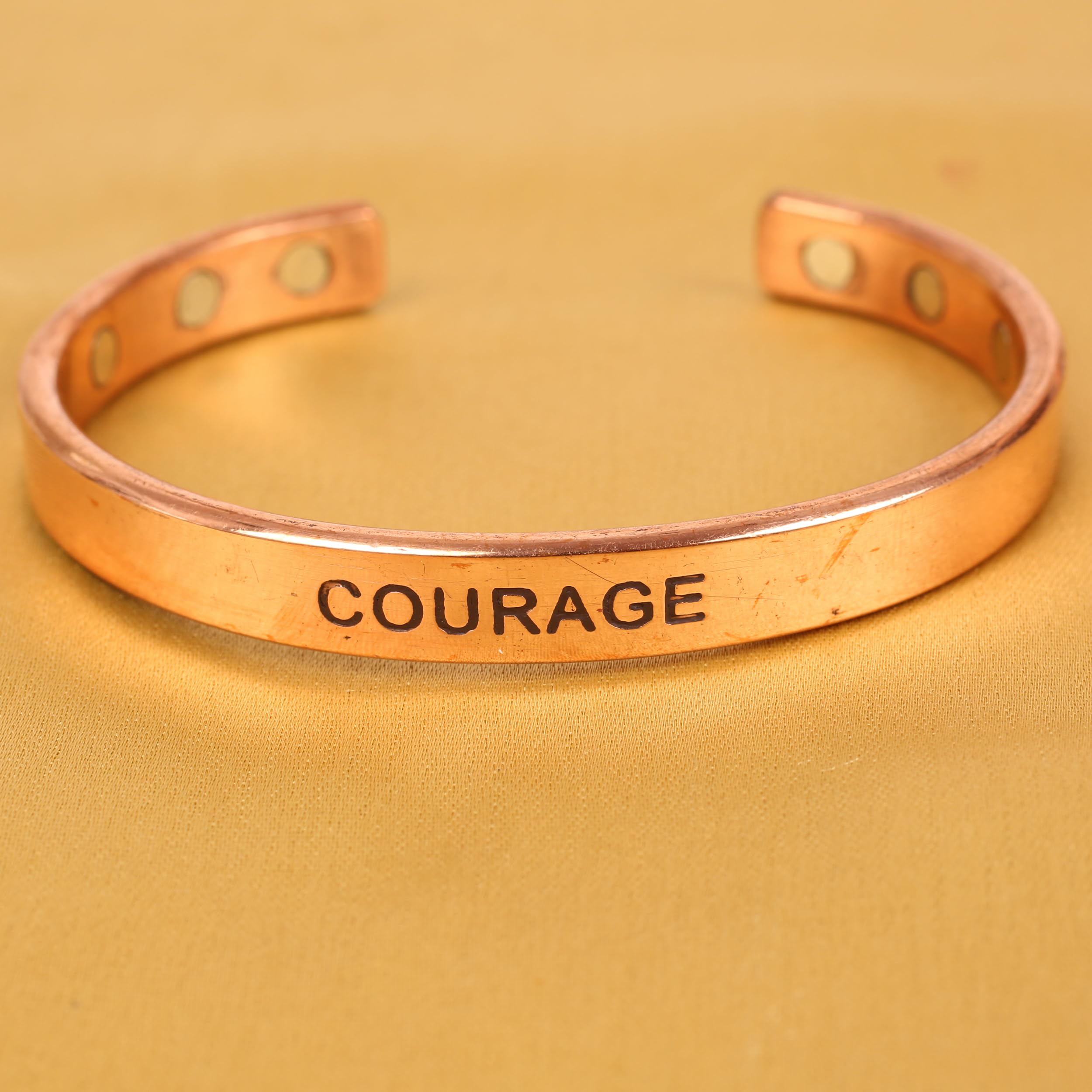 Touchstone engraving COURAGE close-up emphasizing meaningful sentiment