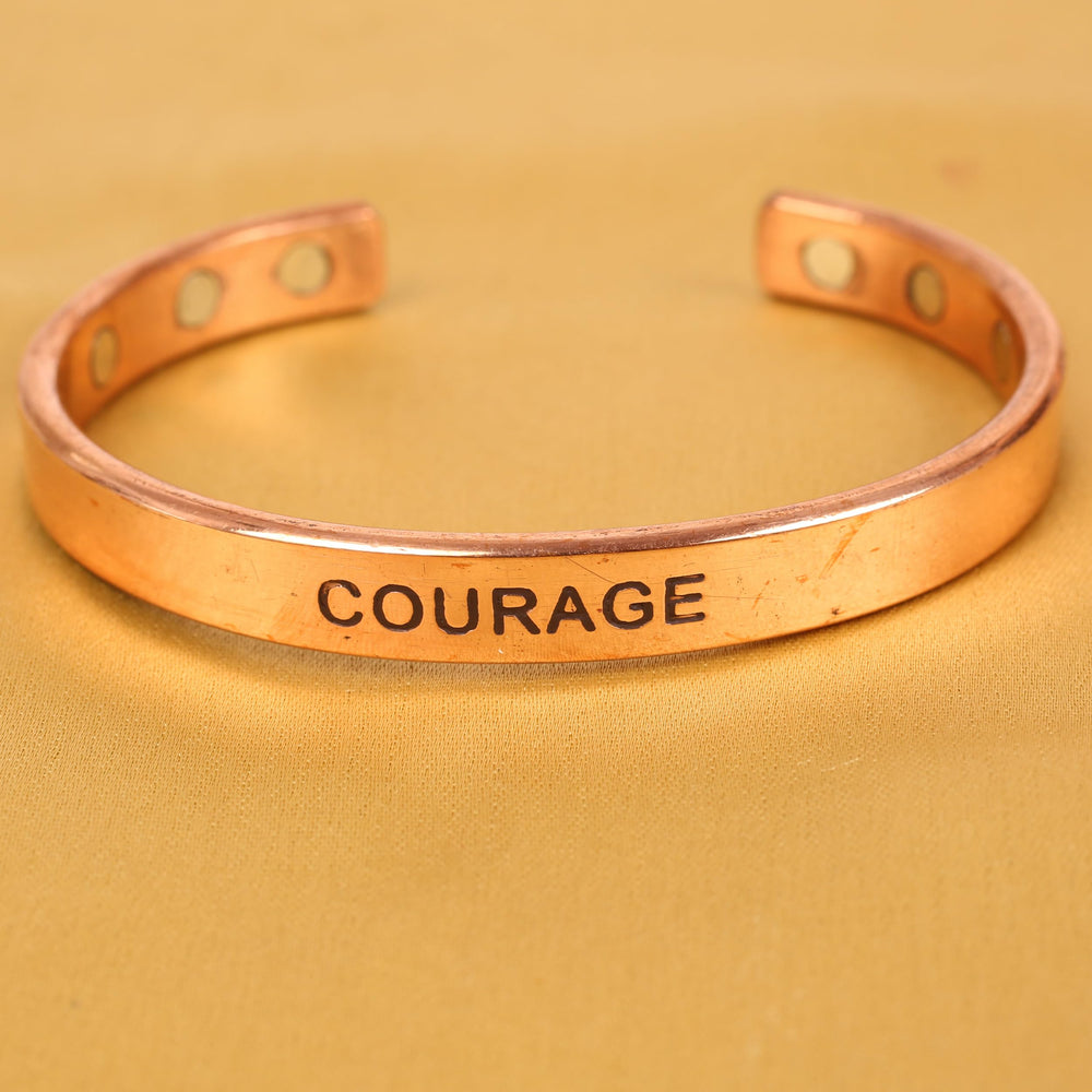 Touchstone engraving COURAGE close-up emphasizing meaningful sentiment