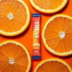 TREVI orange electrolyte stick dissolving in 16 oz water for bold flavor