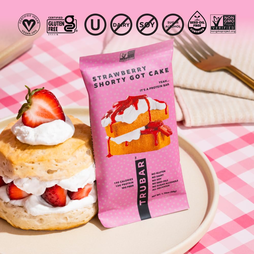 TRUBAR Strawberry Shorty Got Cake bar in hand, portable on-the-go snack.