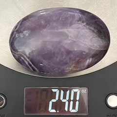 Truewon Amethyst palm stone oval on altar for chakra balancing practice