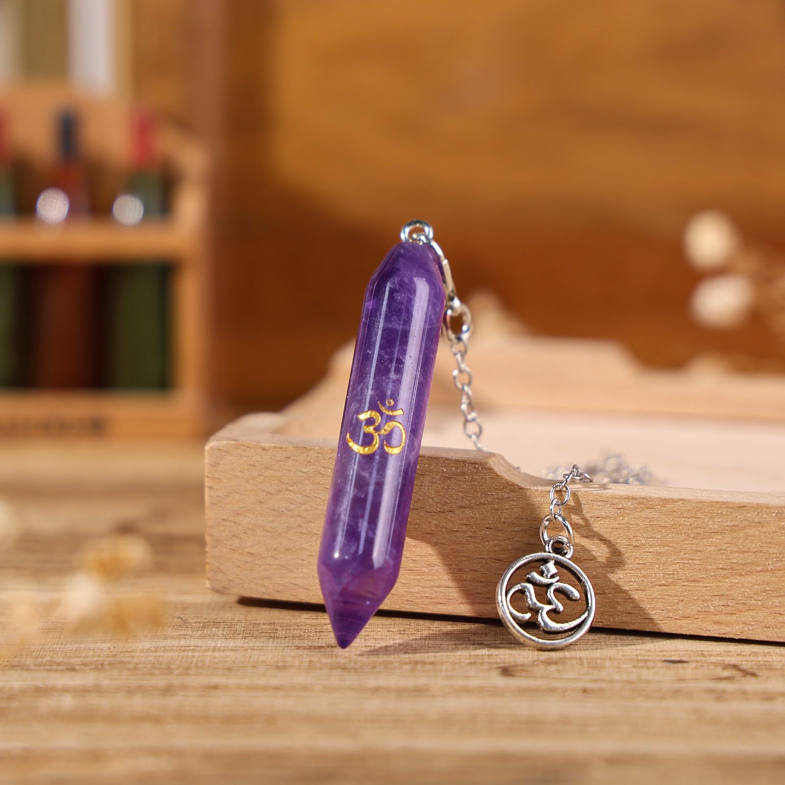 TUMBEELLUWA amethyst pendulum in hand for focused readings