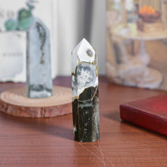 TUMBEELLUWA natural crystal obelisk showing surface texture and color variation.