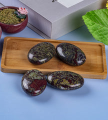 UFEEL Dragon Blood palm stone held in hand for stress relief.