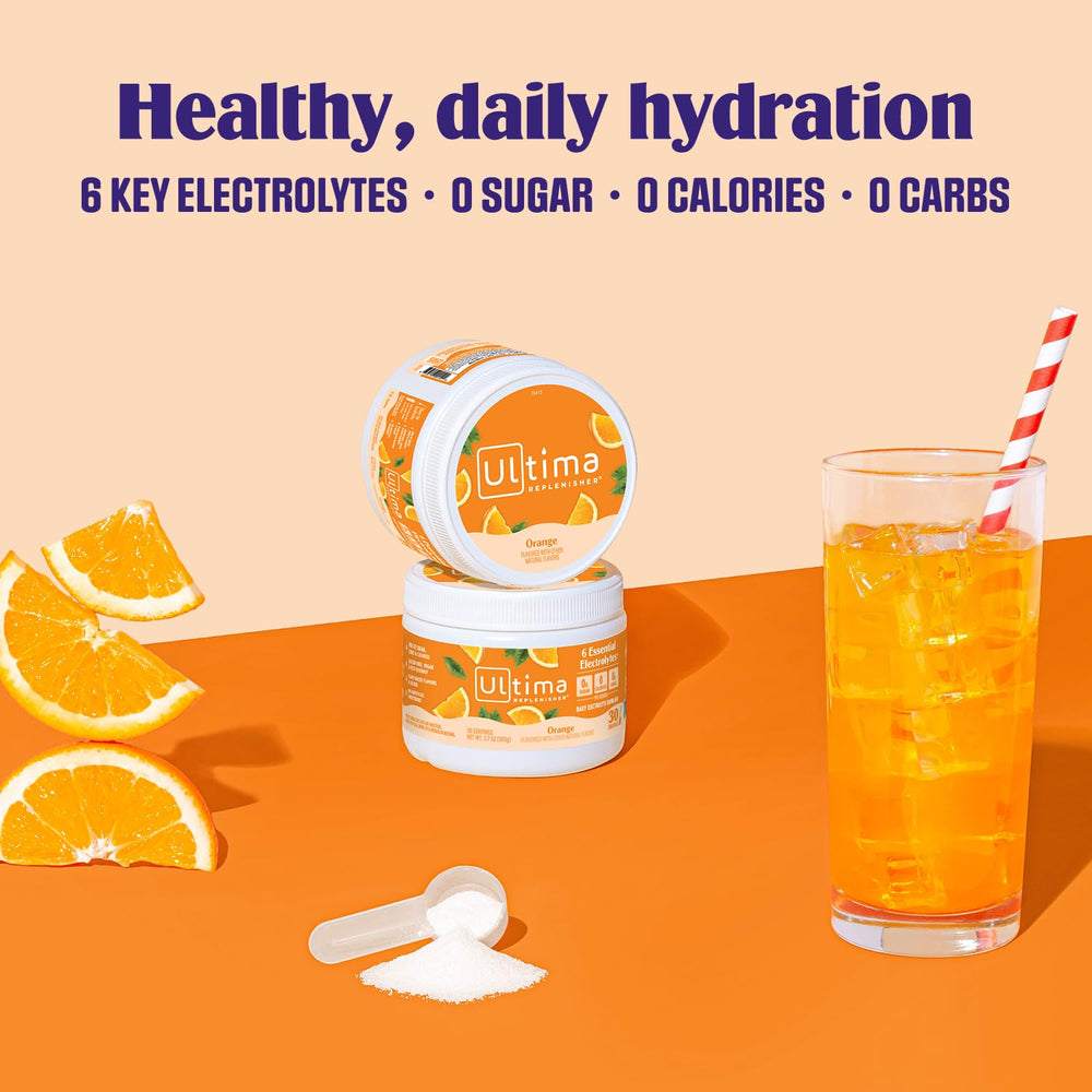 Glass of prepared Ultima Replenisher orange electrolyte beverage.
