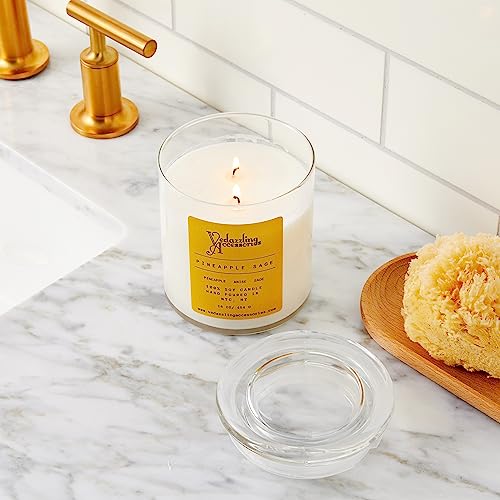 Vedazzling Pineapple Sage candle lit in cozy living room ambiance.