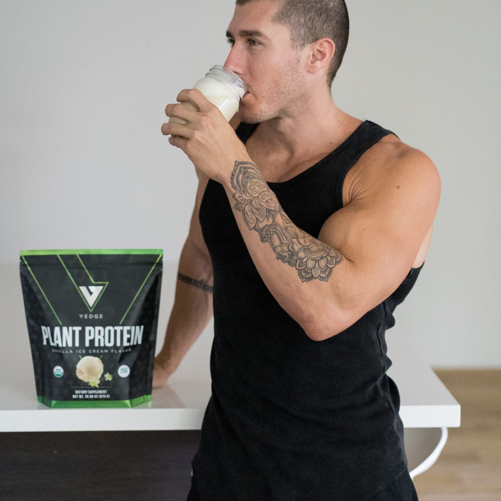 VEDGE vegan protein powder vanilla tub beside a prepared shake