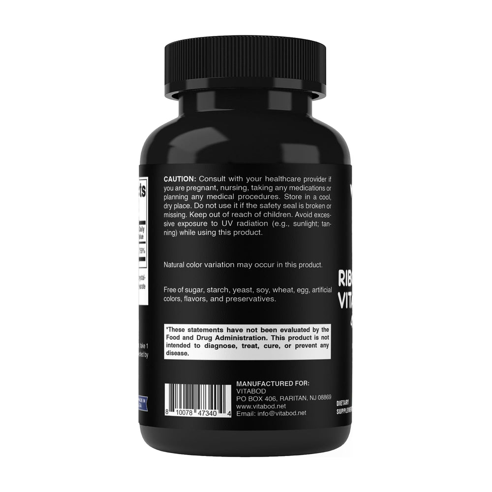 Vitabod bottle with capsules beside a notebook for daily wellness.