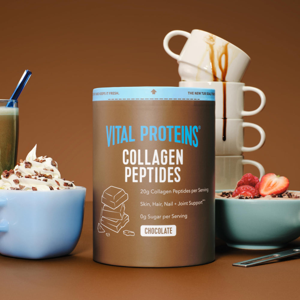 Vital Proteins Collagen Peptides Chocolate powder in measuring spoon for easy daily mix.