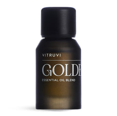 Vitruvi Golden bottle close-up showcases the citrus-spice blend for uplifting spaces