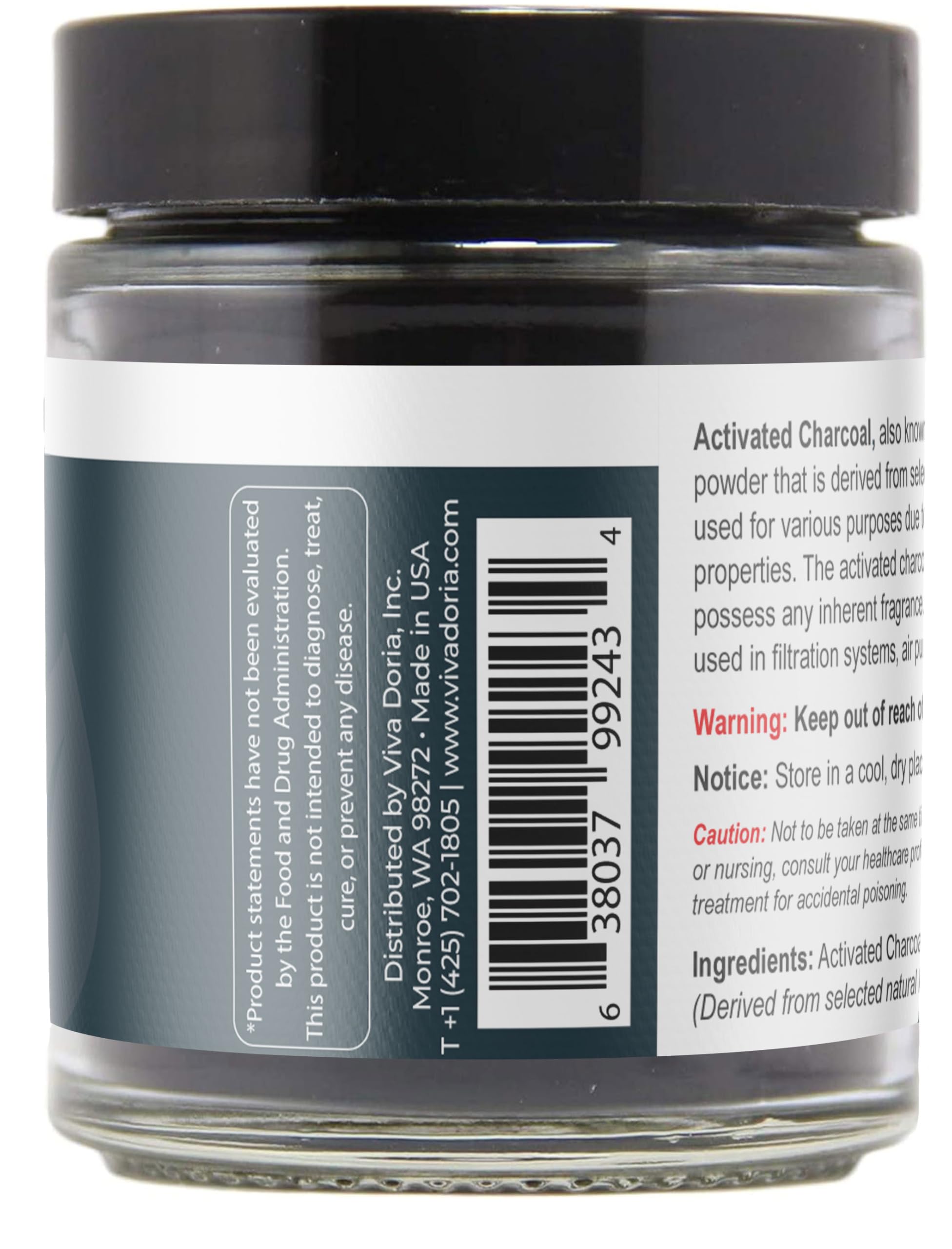 Viva Doria charcoal powder with spoon beside glass jar for easy dosage