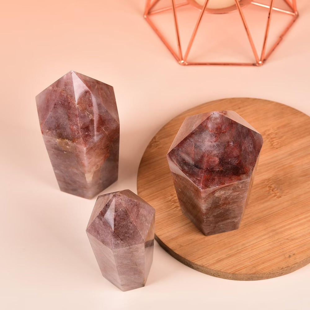 VIZYTOU red hematoid quartz obelisk close-up, highlights hematite inclusions and star-like patterns.
