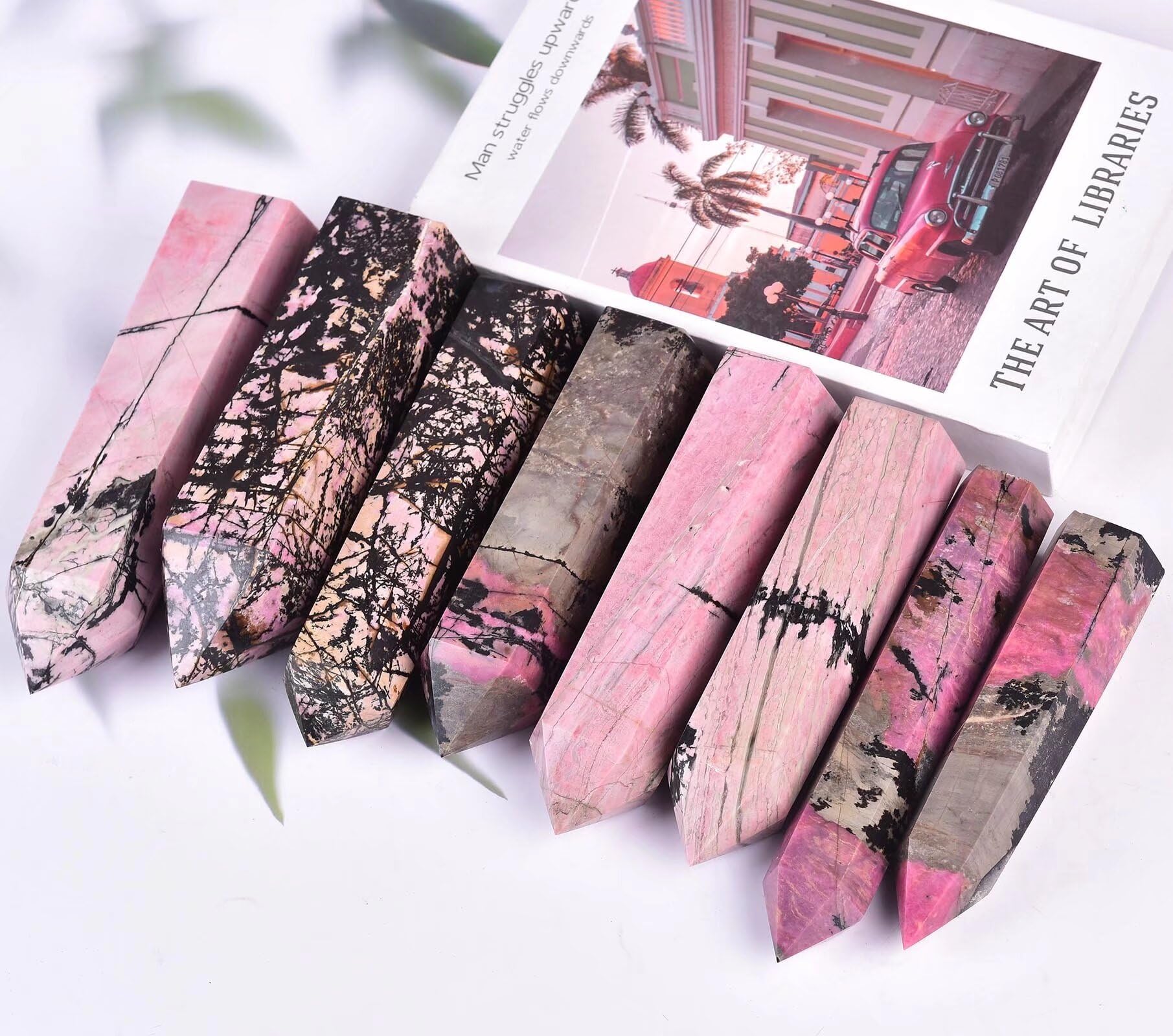 VIZYTOU Rhodonite tower obelisk placed in a living room as a centerpiece