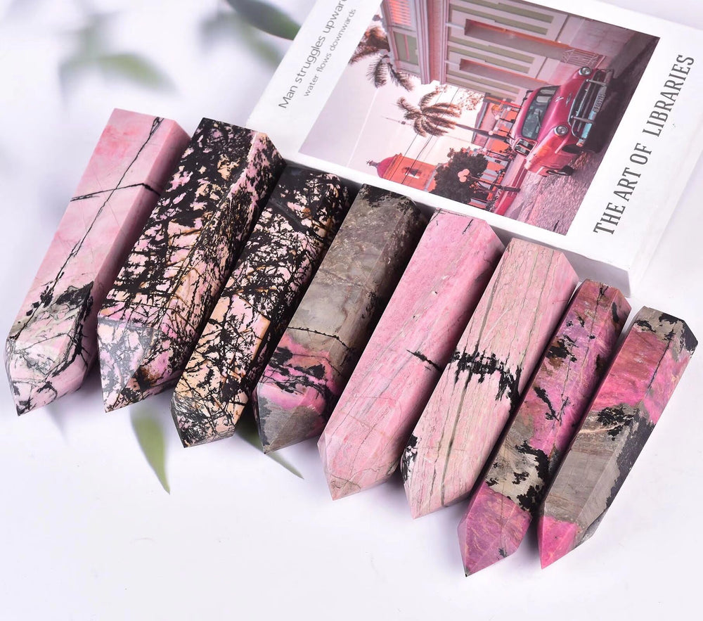VIZYTOU Rhodonite tower obelisk placed in a living room as a centerpiece