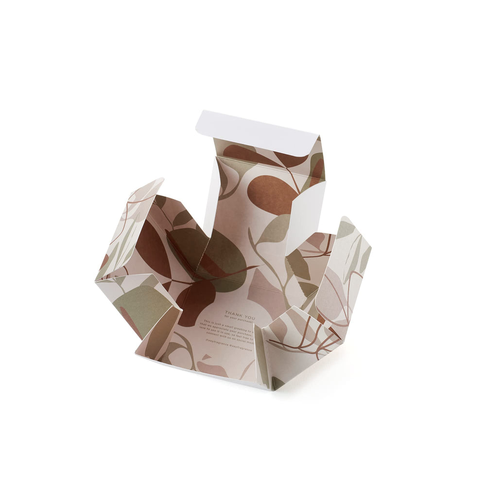 VOY candle amber glow in dim room evokes warm, inviting ambiance