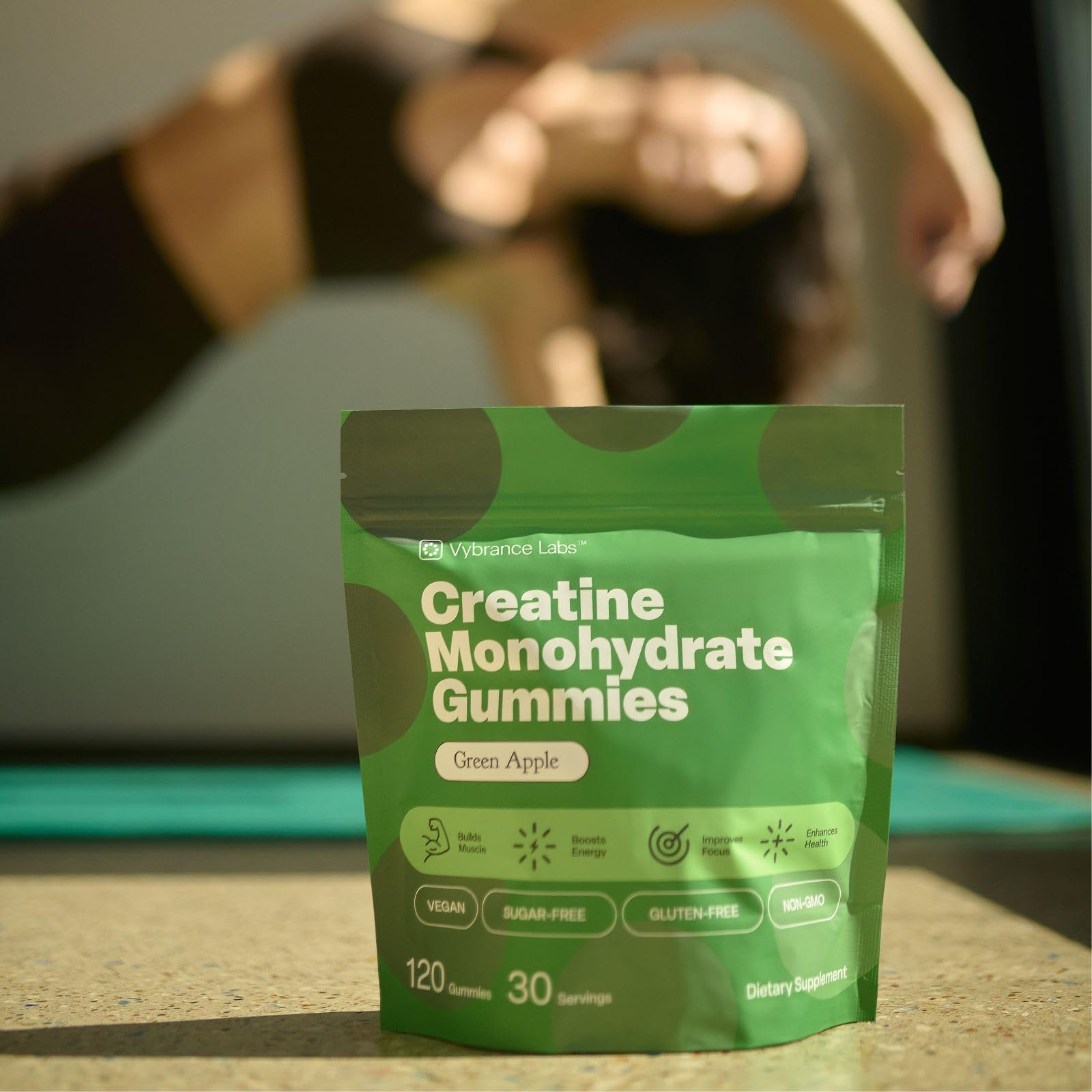 VYBRANCE LABS gummy beside water bottle to suggest hydration and daily routine compatibility