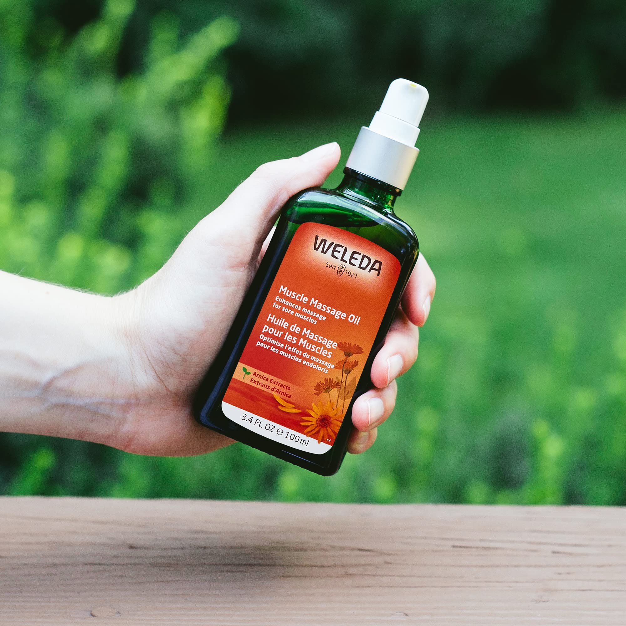 Weleda Arnica Muscle Massage Oil packaging shows a 3.4 oz pump bottle.