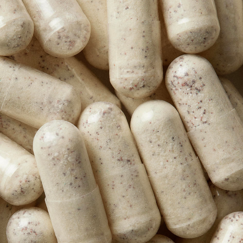 Close-up of WELLBEL Men capsules offering a convenient three-capsule daily dose