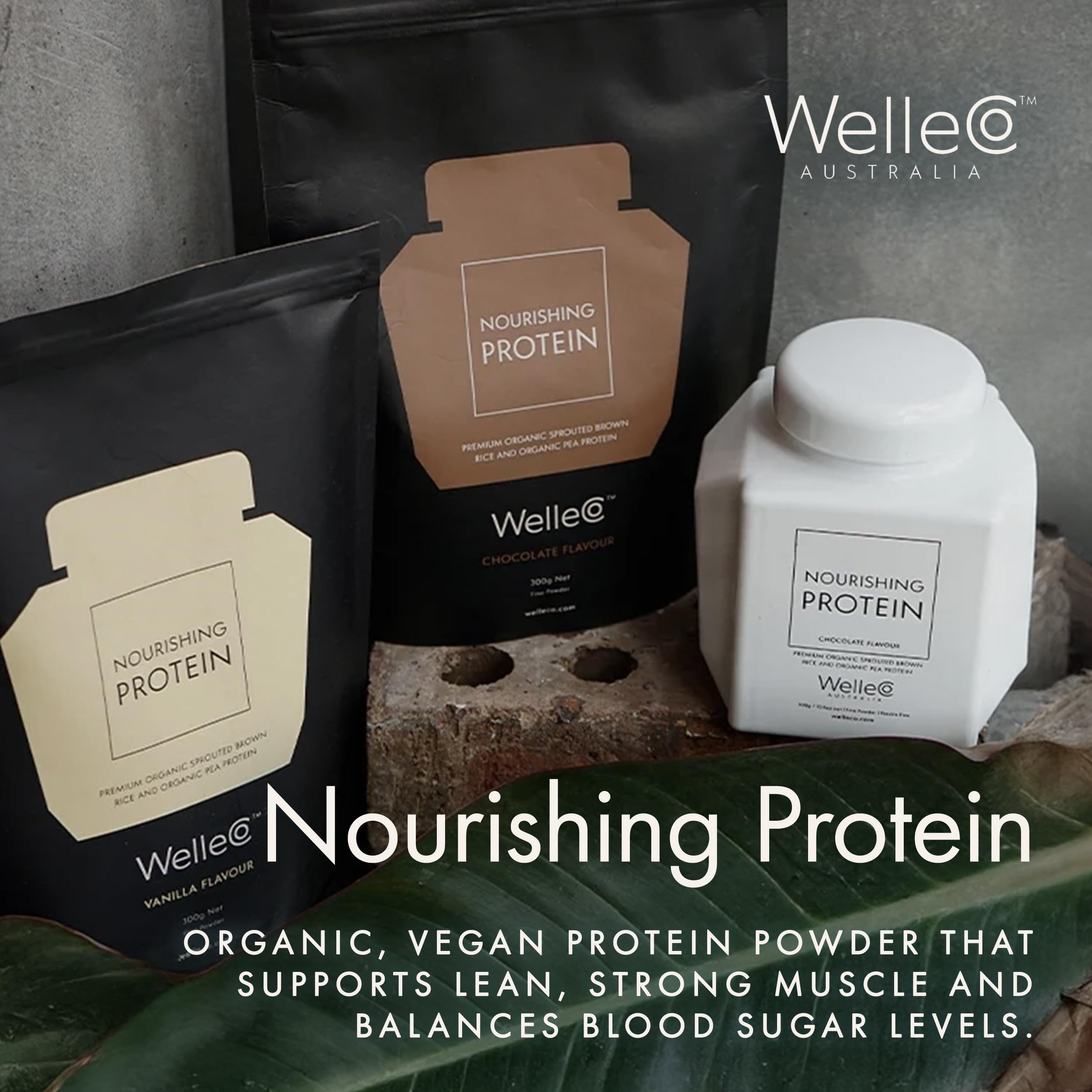Glass of WelleCo plant-based nutrition beside a healthy meal.