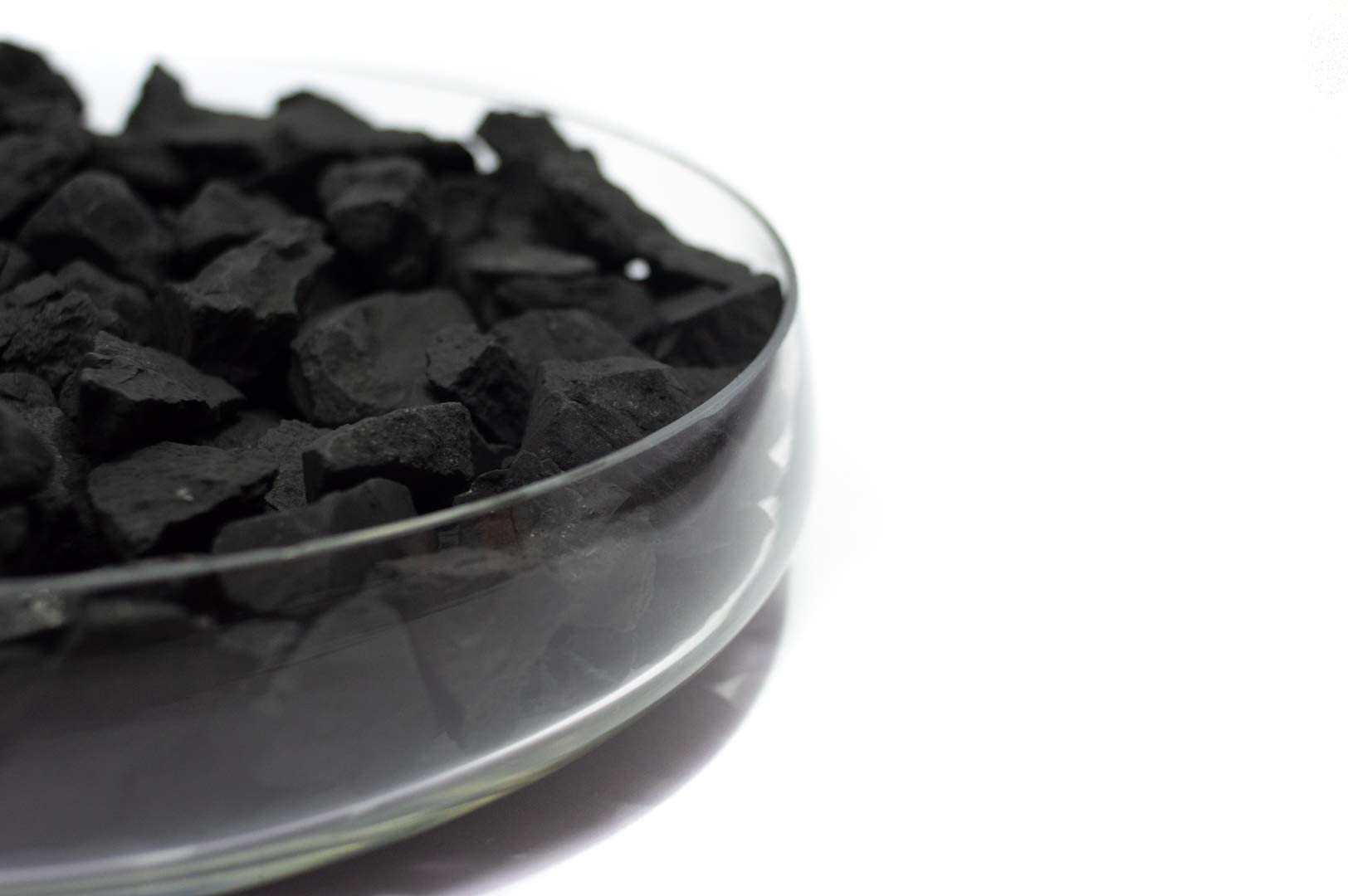 Close-up of textured shungite stones demonstrating natural carbon composition