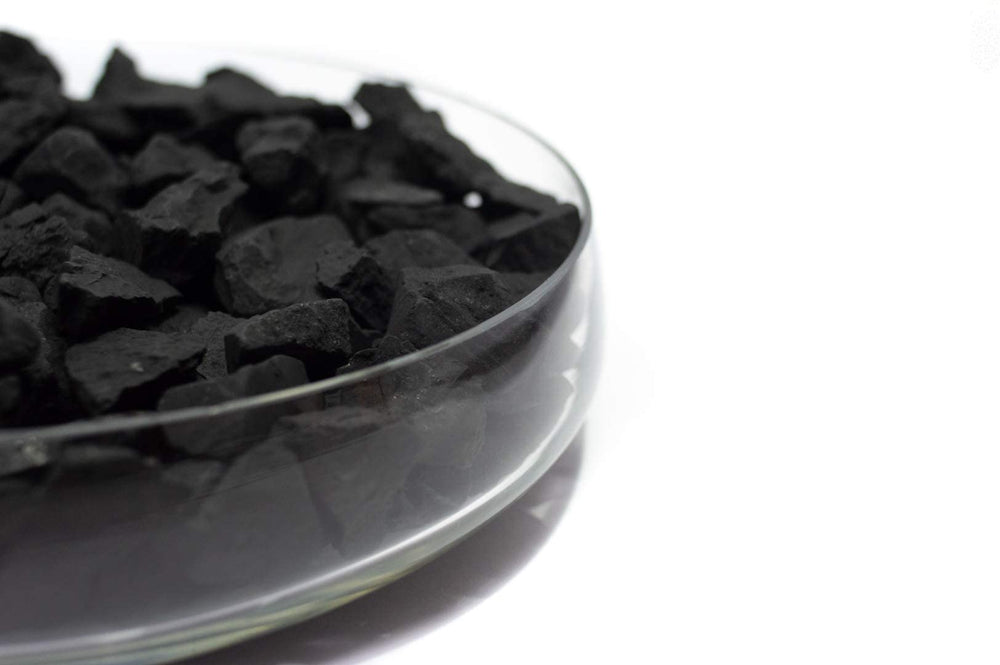 Close-up of textured shungite stones demonstrating natural carbon composition