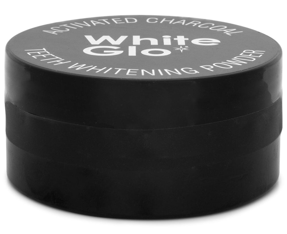 White Glo powder on a wet toothbrush ready for brushing.