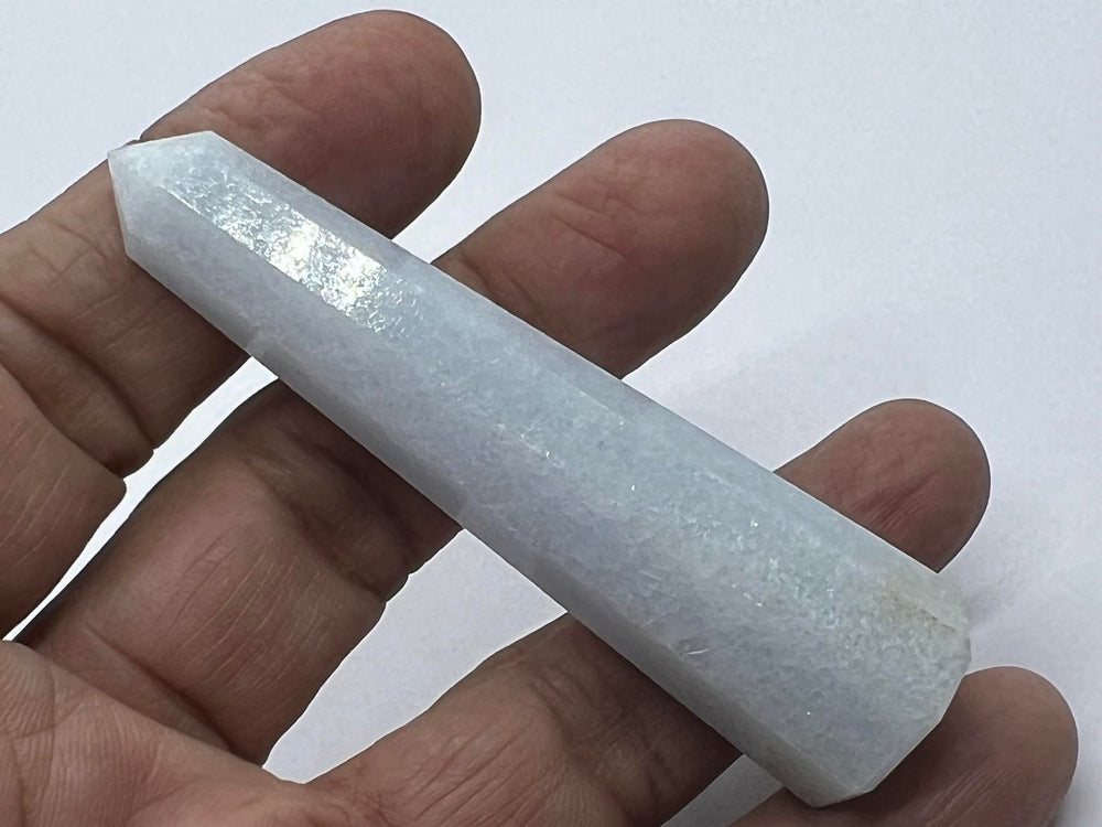 Wholesale Gem Shop Blue Calcite Obelisk polished surface reflects light beautifully.