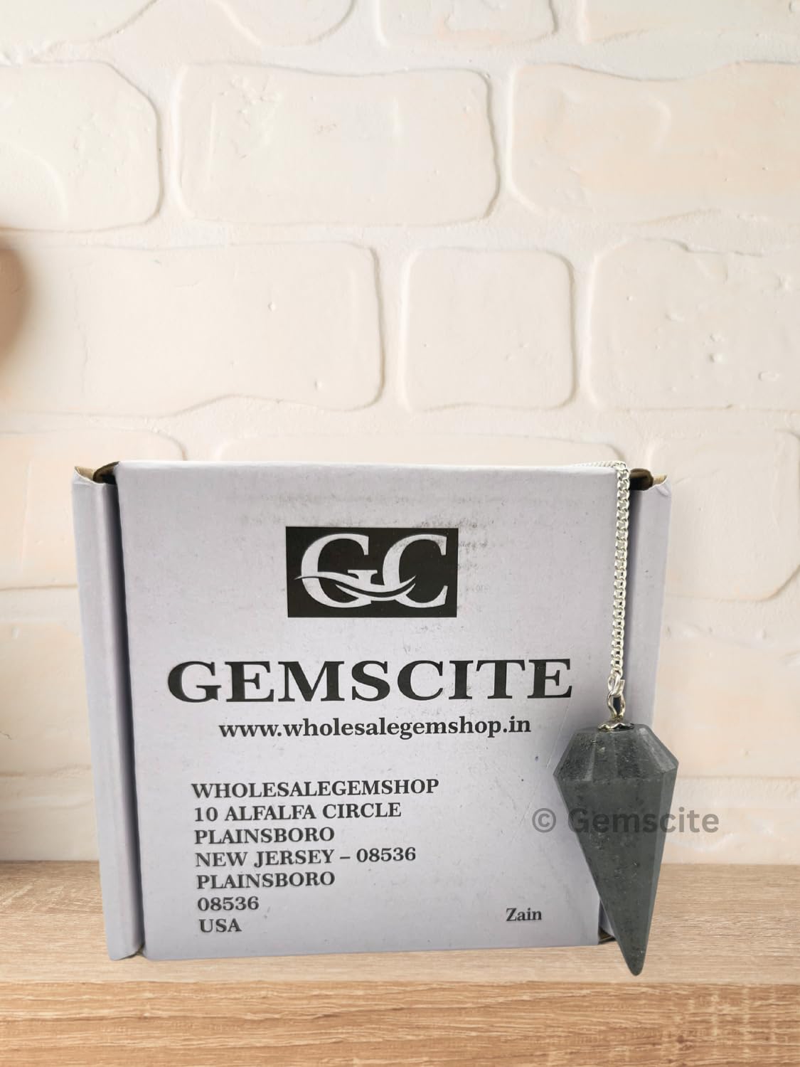 Wholesalegemshop Blue Aventurine Pendulum in hand for focus during practice
